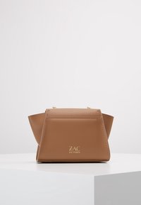 Borsa a mano in pelle marrone con un design strutturato e angolare, hardware dorato e dettaglio del logo. Texture liscia, manici corti e cuciture minime.