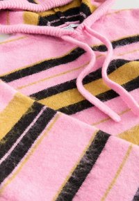Soft knit hoodie with pink, mustard yellow, and black horizontal stripes and a front pocket, featuring drawstrings at the neckline.