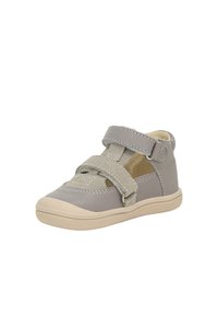 Šedá obuv na suchý zip s hladkým koženým svrškem, béžovou gumovou podrážkou, kontrastním šitím a malými výřezy na bocích.