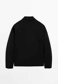 Black long-sleeve jacket with a straight back, buttoned cuffs, and a small collar, displayed on a plain white background.