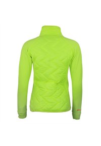 Veste légère vert néon avec un motif matelassé dans le dos, manches longues et col haut. Présente un logo discret sur le poignet.