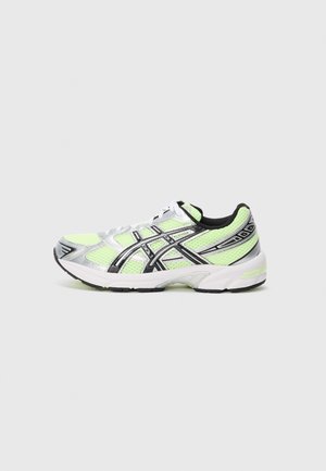 Neon green and silver athletic shoe with black and white detailing, mesh upper, and cushioned white sole on a plain background.