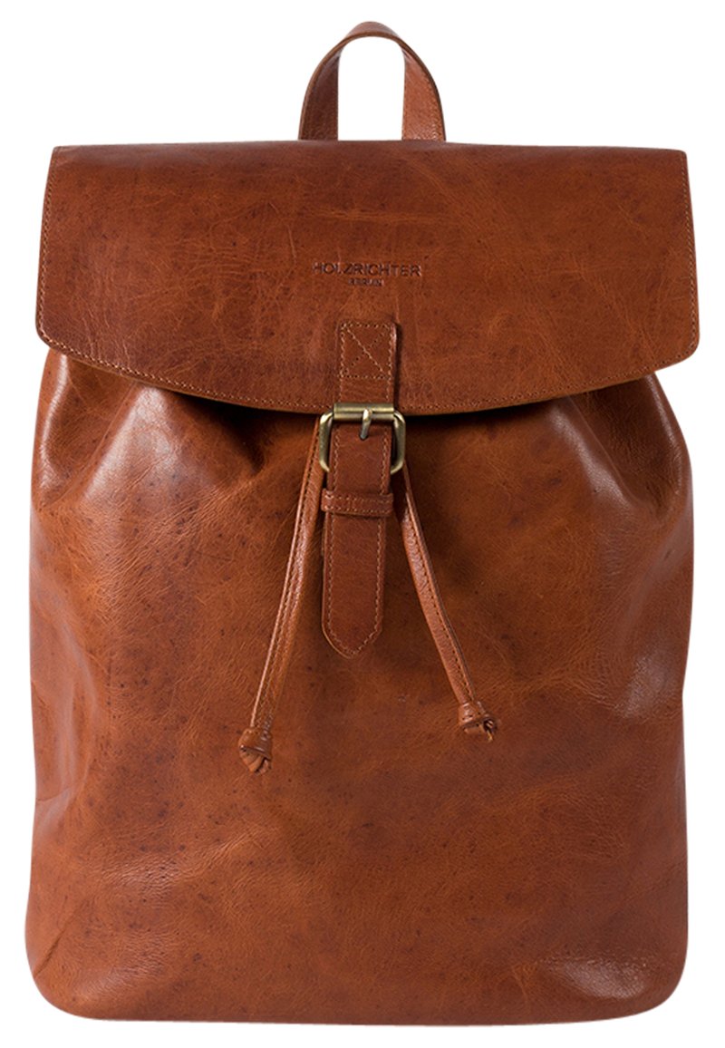 Brown leather backpack with a flap closure, adjustable straps, and a drawstring. Features a smooth texture and minimal branding.