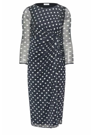 Vestido hasta la rodilla azul marino con lunares blancos, mangas largas transparentes y detalle fruncido con torsión en la cintura.