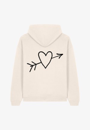 Felpa color crema con un design di un cuore nero con una freccia sul retro, realizzata in un tessuto morbido con polsini e vita a coste.