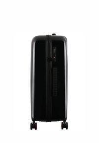Black hard-shell suitcase with a smooth surface, dual zippers, built-in lock, and four red-wheel casters for mobility.