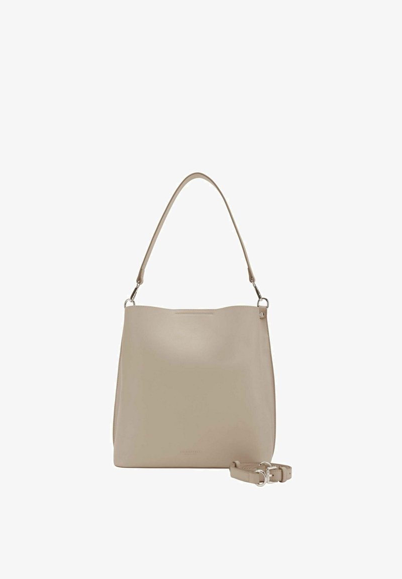 Sac à main en cuir beige avec une poignée supérieure et une bandoulière réglable amovible placée à côté sur un fond blanc.