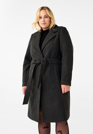 Donkergrijze wollen jas met een ceintuur in de taille, geknipte revers en lange mouwen. Heeft een rechte snit en zijzakken. Gelaagd stof.