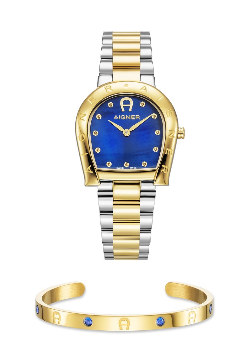 Orologio oro e argento con quadrante blu, dotato di accenti dorati e gemme; accompagnato da un bracciale rigido in oro con pietre blu.