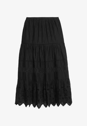 Black tiered skirt with elastic waistband, lace inserts, and scalloped hem featuring floral cutout embroidery.