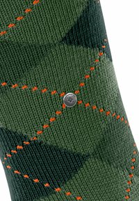 Calza verde con un motivo a rombi, con dettagli in cucitura arancione e un'etichetta logo argentata. Realizzata in materiale a maglia testurizzato.