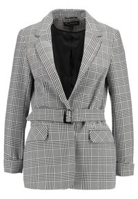 Kvinnors grå och svart rutiga kavaj med knytmidja, kavajkrage och två framfickor. Fodrad insida med svart finish.