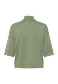 Rövid ujjú, galléros felső világoszöld színben. Puha, texturált anyagból, laza szabással és széleivel szegve. Látható minták vagy díszítések nélkül.