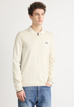 Cream lightweight polo sweater with a zipper closure, long sleeves, and ribbed accents. Features a small black "BOSS" logo on the chest.