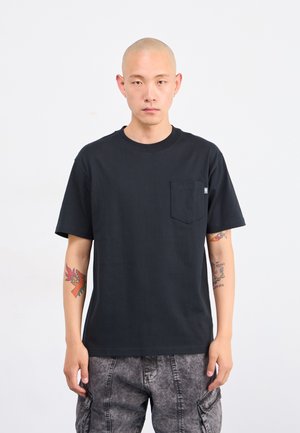 Black cotton t-shirt with a round neck and short sleeves, featuring a chest pocket. The fabric appears smooth with a relaxed fit.