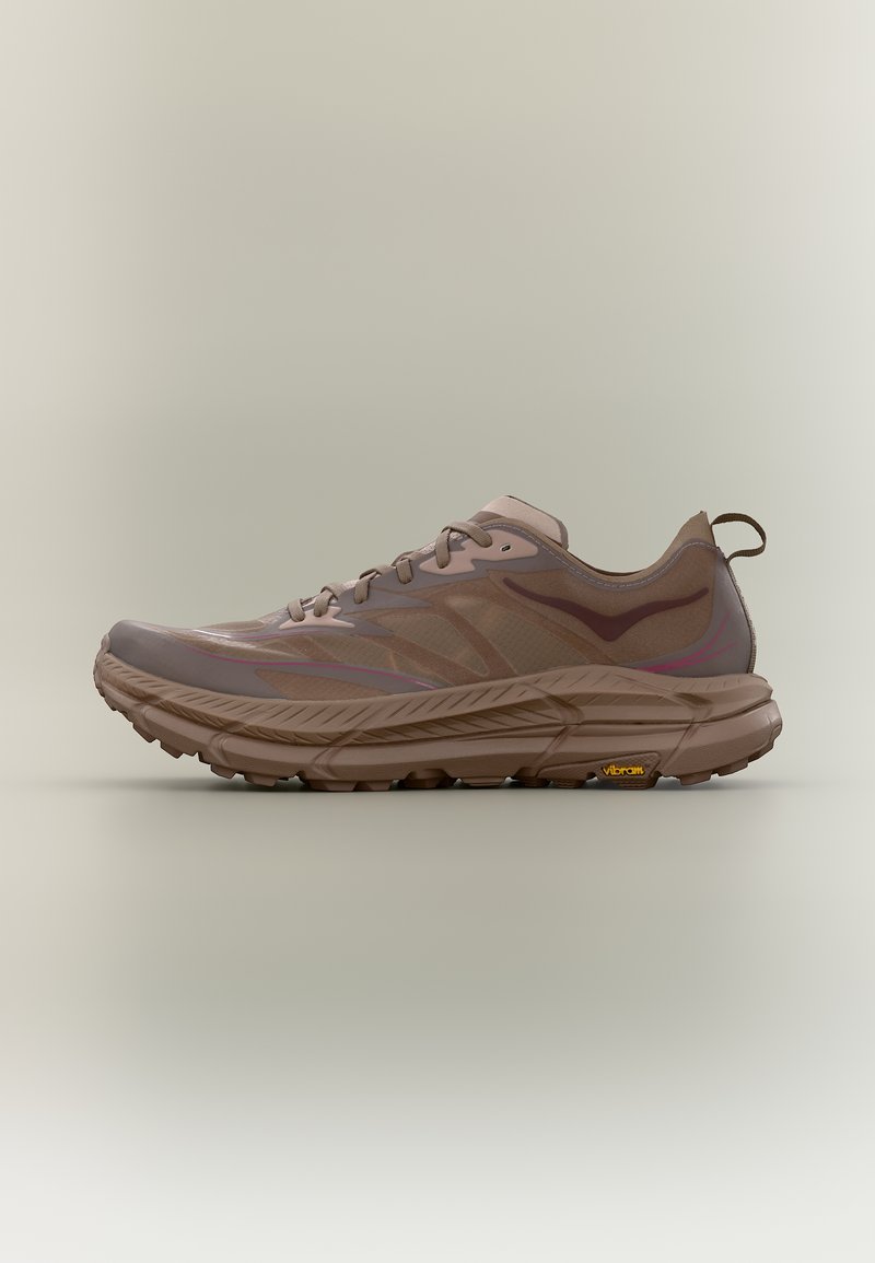 Καφέ αθλητικό παπούτσι χαμηλής κορυφής με κλείσιμο με κορδόνια, παχύ υφασμένο πέλμα και θηλιά στο πίσω μέρος, παρουσιασμένο σε ουδέτερο φόντο.