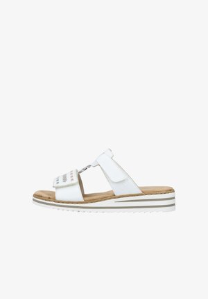 White sandal with a toe loop design, soft footbed, Velcro straps, and a striped platform sole. Features perforated accents on the upper.