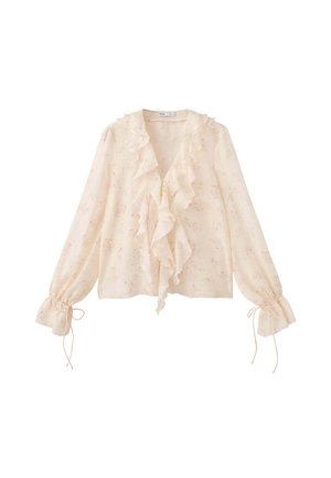 Blusa de manga larga color beige claro con pequeño estampado floral, volantes en el frente y detalles de lazo en los puños fruncidos.