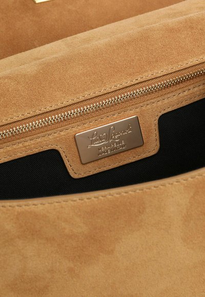 Tan suede bag interior with a zipper pocket and metal brand label stating "Luisa Spagnoli, Vera Pelle, Made in Italy."