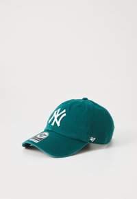 Teal baseball cap made of cotton with a white embroidered logo on the front, curved brim, and an adjustable strap at the back.