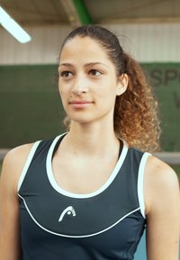 Black athletic tank top with white accents, featuring a round neckline and textured fabric. Logo displayed at the center.