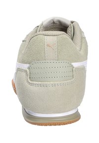 Zapatillas de ante verde con parte superior de malla, franja lateral blanca, suela de color claro y acento de talón texturizado. Presenta sutiles detalles de costura.