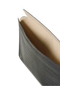 Black crocodile leather envelope clutch with beige suede interior, slightly open showing soft lining and gold embossed brand logo inside.