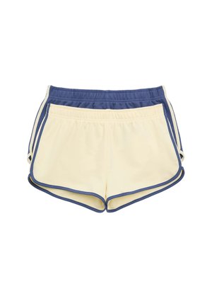 To par atletiske shorts med elastisk talje, lagt oven på hinanden, det forreste par er cremefarvet med blå kant, det bageste marineblåt med creme kant.