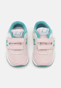 Light pink sneakers with teal accents, mesh and suede materials, dual Velcro straps, and a rounded white sole. Model 997H.