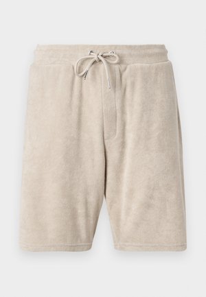 Beige frotté shorts med elastisk talje og justerbar snor. Har en enkelt forlommes og knælangt design.