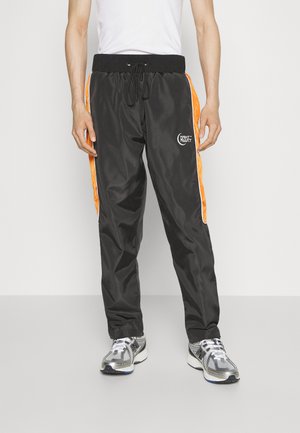 Night Addict NAMOON UNISEX - Pantaloni sportivi - black/orange