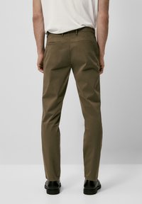 Kaki broek van katoen met een slanke pasvorm, voorzien van achterzakken, een gladde textuur en omgezoomde enkels. Minimalistische stijl zonder zichtbare patronen.