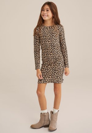 Leopardmönstrad klänning med långa ärmar, gjord av mjukt tyg. Har en figurnära silhuett och rund halsringning. Bärs med bruna anklarstövlar.