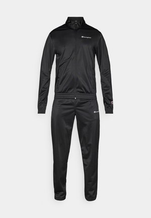 Tuta nera realizzata in materiale liscio e leggero. Presenta una giacca con zip, colletto alto e polsini e vita elasticizzati.