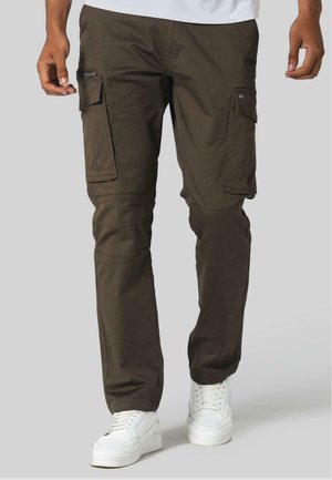 Cargo pantalons van donkerbruin stof, met meerdere zakken en een relaxte pasvorm. Details zijn onder meer ritssluitingen aan de zijkanten en versterkte knieën.