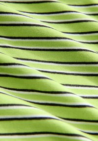 Green fabric featuring horizontal stripes in black and white. The texture is soft and textured, with a slight stretch.