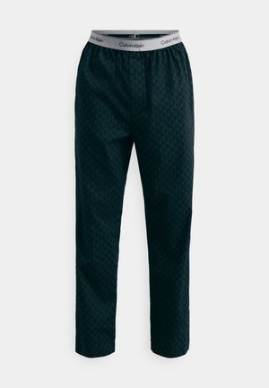 Calvin Klein bukser; mørkeblå med geometrisk mønster; elastisk talje med logo; løs pasform; glat, let vævning.