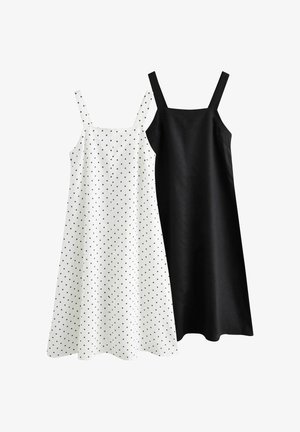 Two sleeveless A-line dresses with square necklines, one white with black polka dots and one solid black, displayed side by side.