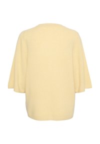 Šviesiai geltonas megztinis, laisvo kirpimo, trumpomis rankovėmis ir apvalia iškirpte. Minkšta tekstūra ir be siūlių konstrukcija.