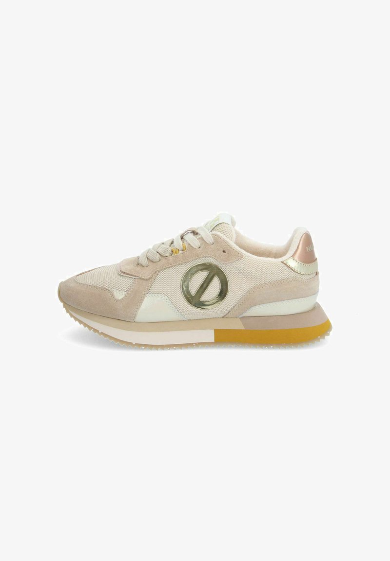 Sport shoes in beige and white mesh with beige suede accents. Features a metallic emblem, cushioned sole, and textured rubber outsole.