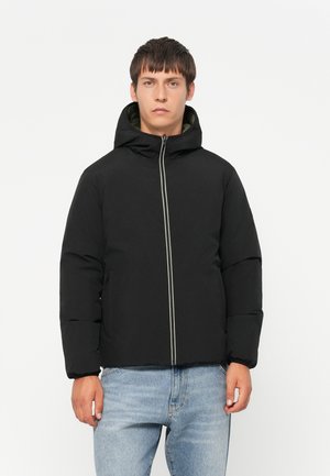 Black padded jacket with a hood, featuring a central zipper and contrasting white piping. Smooth texture and minimalist design.