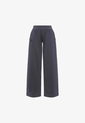 Pantalon de survêtement large gris foncé en tissu doux, doté d'une taille haute et de deux poches latérales, avec un petit logo sur la jambe gauche.