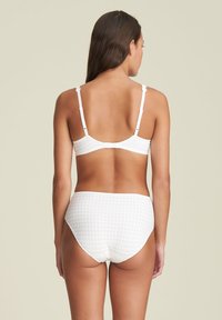 White checkered bikini set featuring a textured fabric, adjustable straps, and a high-waisted bottom with a smooth band.
