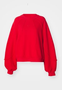 Červená oversized mikina s kulatým výstřihem, žebrovanými manžetami a bočními švy. Na hrudi je malý logo Nike a texturovaná tkanina.