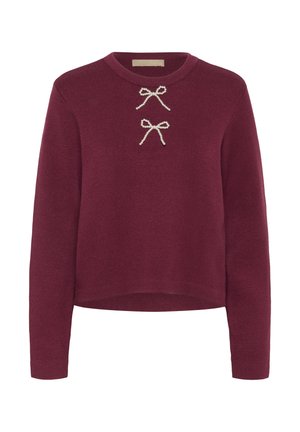 Burgundia värvi pikade varrukatega sviiter, ribatekstuuriga ning ees kahel dekoratiivsel pärlakkentil. Ümmargune kaelus, lühikeseks lõigatud mudel.