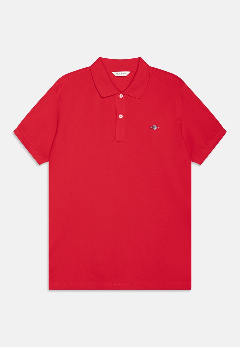 Röd polo skjorta i mjuk bomull, med klassisk krage, korta ärmar och en liten, diskret logotyp på vänster bröst.
