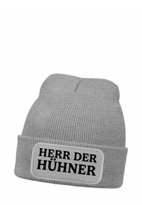 Gray knit beanie with a folded cuff. Features a rectangular patch displaying the text "HERR DER HÜHNER" in bold black letters.