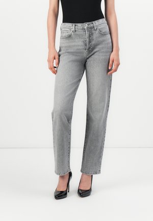 Lichtgrijze high-waisted jeans met een iets relaxte pasvorm. Gemaakt van denim, met voorzakken en een subtiele textuur. Gecombineerd met zwarte hakken.