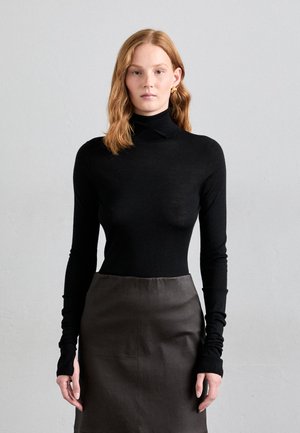 Black turtleneck sweater with long sleeves, smooth texture. Paired with a dark gray pencil skirt, featuring a sleek, minimalist design.