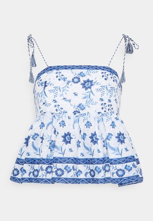 Top de estampado floral en colores azul y blanco, con diseño peplum, tirantes ajustables con borlas y detalles decorativos en bandas.